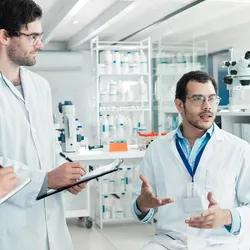 Scientists discussing ideas with active listening in the lab