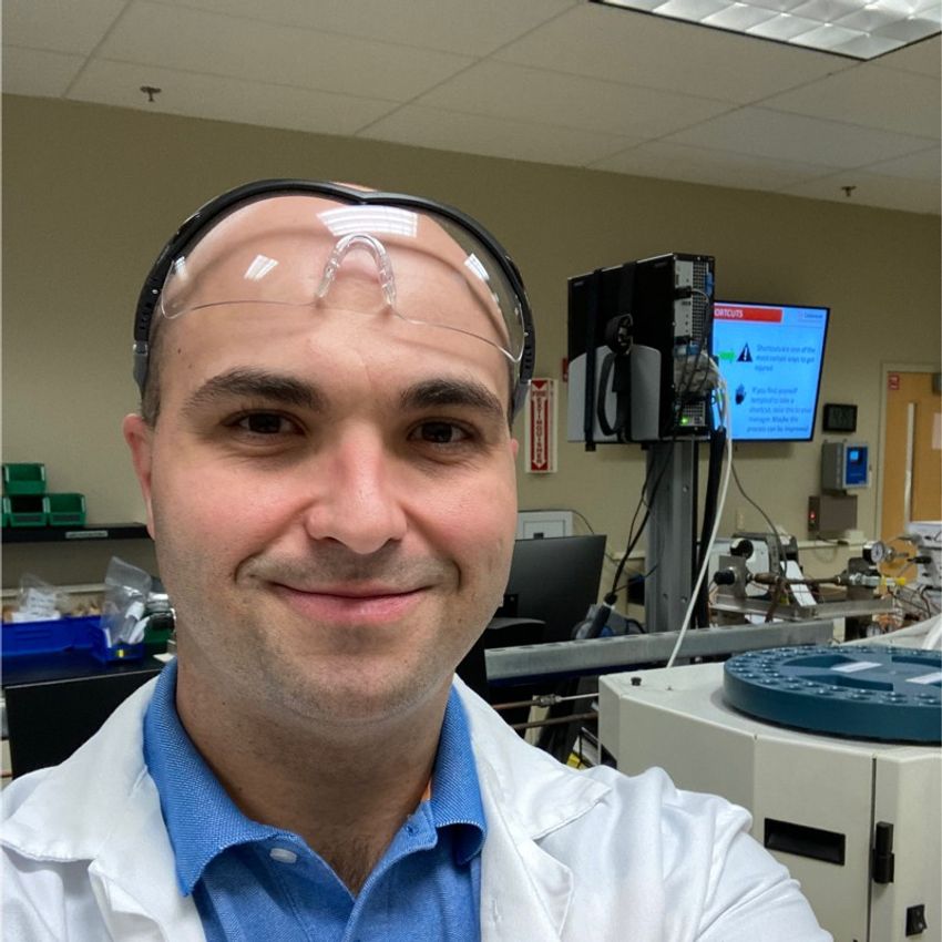 Laboratory professional with safety goggles in lab setting