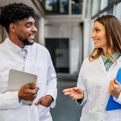 Diverse team of scientists engaging in conversation about workplace support