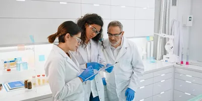 Three lab professionals discussing safety procedures
