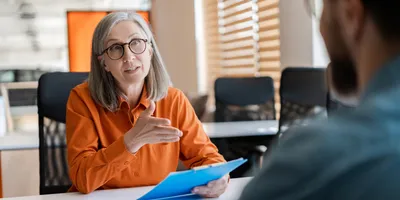 Hiring manager conducting a structured interview with a candidate about AI in hiring.