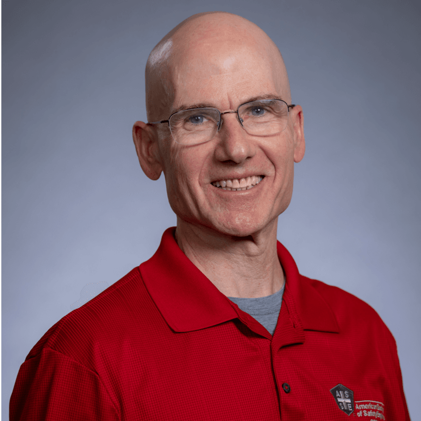 Headshot of a professional in a red polo, smiling