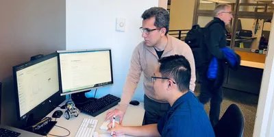 Researchers collaborating on computational chemistry using AI framework