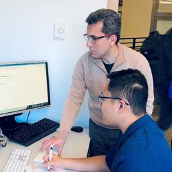 Researchers collaborating on computational chemistry using AI framework
