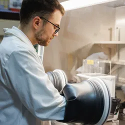 Male scientist using glove box