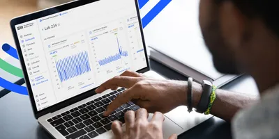 Scientist using laboratory monitoring software on a laptop