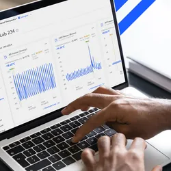Scientist using laboratory monitoring software on a laptop