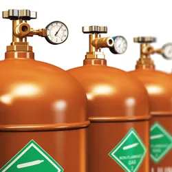Row of filled helium tanks for laboratory use