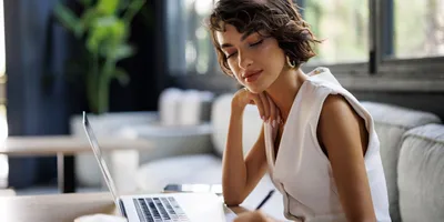 Professional woman working on laptop, focusing on her career plan