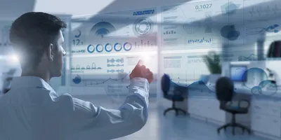 Back view of young businessman touching digital interface with financial graphs on blurry office interior background
