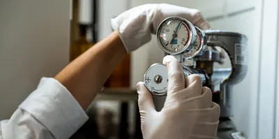 Close-up of a hand adjusting a gas pressure regulator