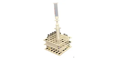 A handheld SPEedy solid phase extraction device sits in a laboratory test tube rack demonstrating its compact footprint.