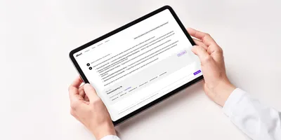 A scientist in a white lab coat holds a tablet displaying the Ask Albert AI interface returning formulation candidates in response to a natural-language chemistry query.