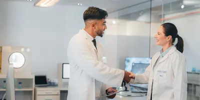 Science, partnership and lab team handshake on collaboration on medical project for innovation in medicine or cancer research.