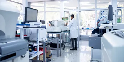 African American scientist working in laboratory filled with high-end instruments