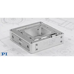 The PI P-733K110 aluminum XYZ piezo nanopositioning stage positioned on engineering blueprint drawings, showing connectors and precision flexure housing.