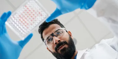 Scientist examining a plate for new approach methodologies in chemical testing