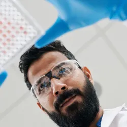Scientist examining a plate for new approach methodologies in chemical testing