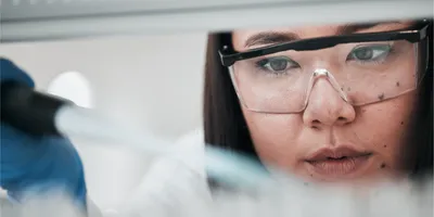 Close-up of a scientist handling drug compounds in a laboratory.