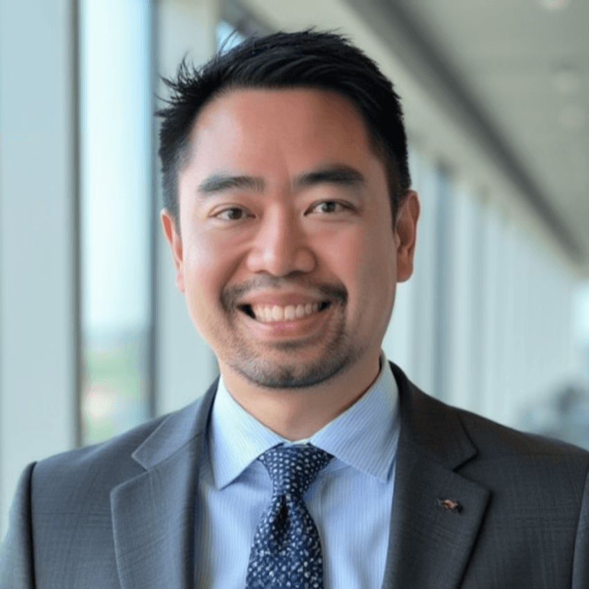 Smiling professional in a suit at a clinical lab