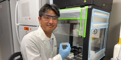 Researcher holding organ-on-chip device for toxicity testing