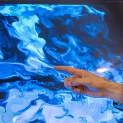 Person interacting with fluid dynamics simulation for turbulence research