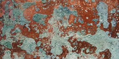 Oxidized copper surface showing green and blue corrosion patterns