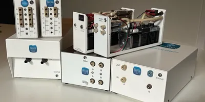 The full DEGASi NG HPLC degasser family from Biotech Fluidics, including Classic, FlatFilm, and Prep models in white housings displayed on a laboratory bench.