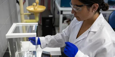 Scientist weighing a sample on a scale