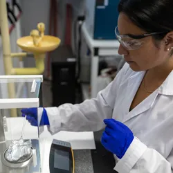 Scientist weighing a sample on a scale