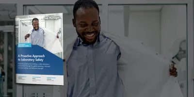 Smiling male medical worker wearing lab coat while standing in laboratory
