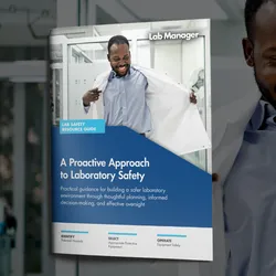Smiling male medical worker wearing lab coat while standing in laboratory