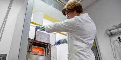 Scientist using a laboratory oven for sealed vessel heating