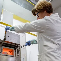 Scientist using a laboratory oven for sealed vessel heating