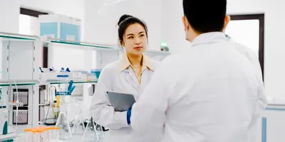 Lab manager and lab staff member meeting in lab, prioritizing lab safety