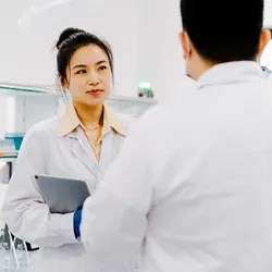 Lab manager and lab staff member meeting in lab, prioritizing lab safety
