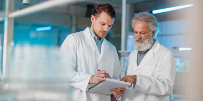 Two lab staff reviewing documentation