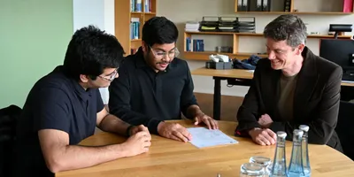 Researchers discussing carbene chemistry techniques.